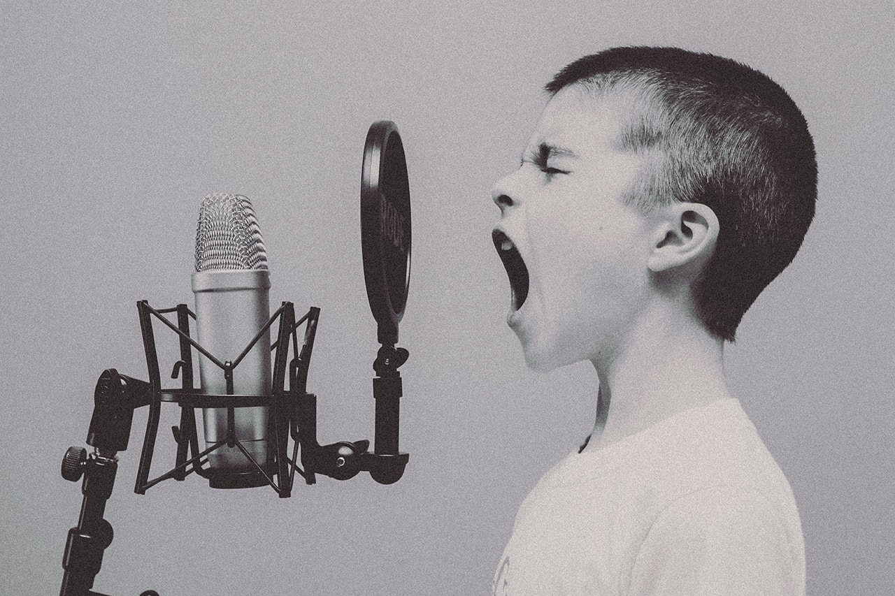 Boy shouting at a studio microphone