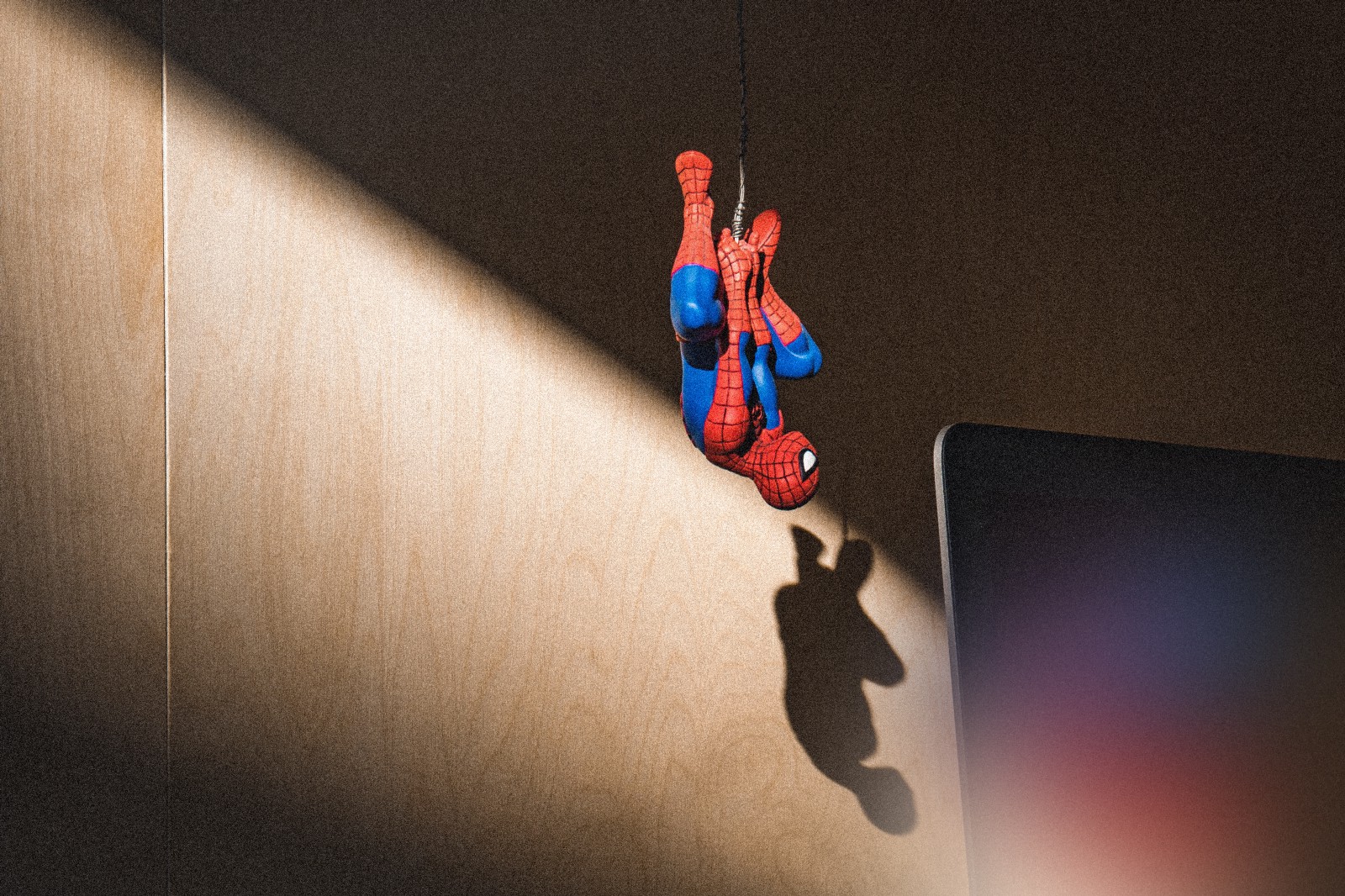 Spider-man figurine hanging upside down