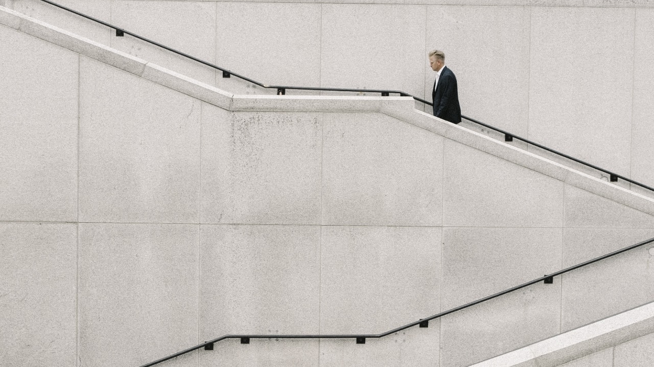 Distance view of an office person climbing stairs