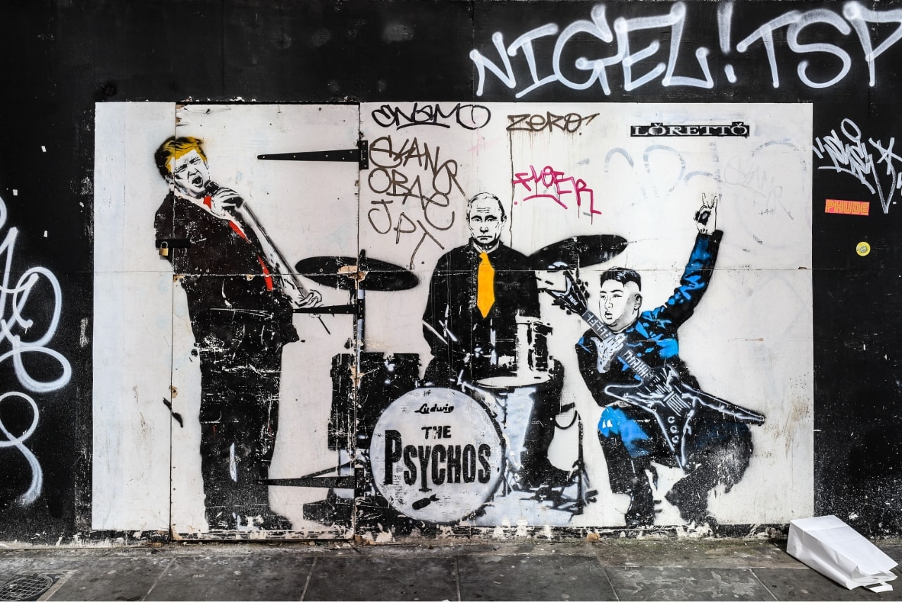 Street graffiti artwork of a music band featuring Donald Trump, Putin, and Xi Jinping