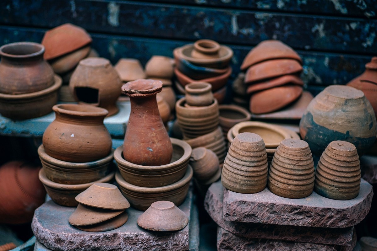 Bunch of brown earthen pots stacked on top of each other